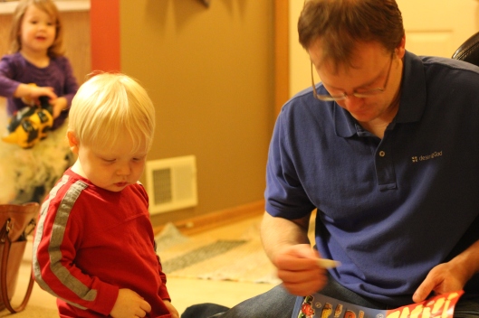 Carson (left) and David (right) focusing on their own "Cars" sticker book